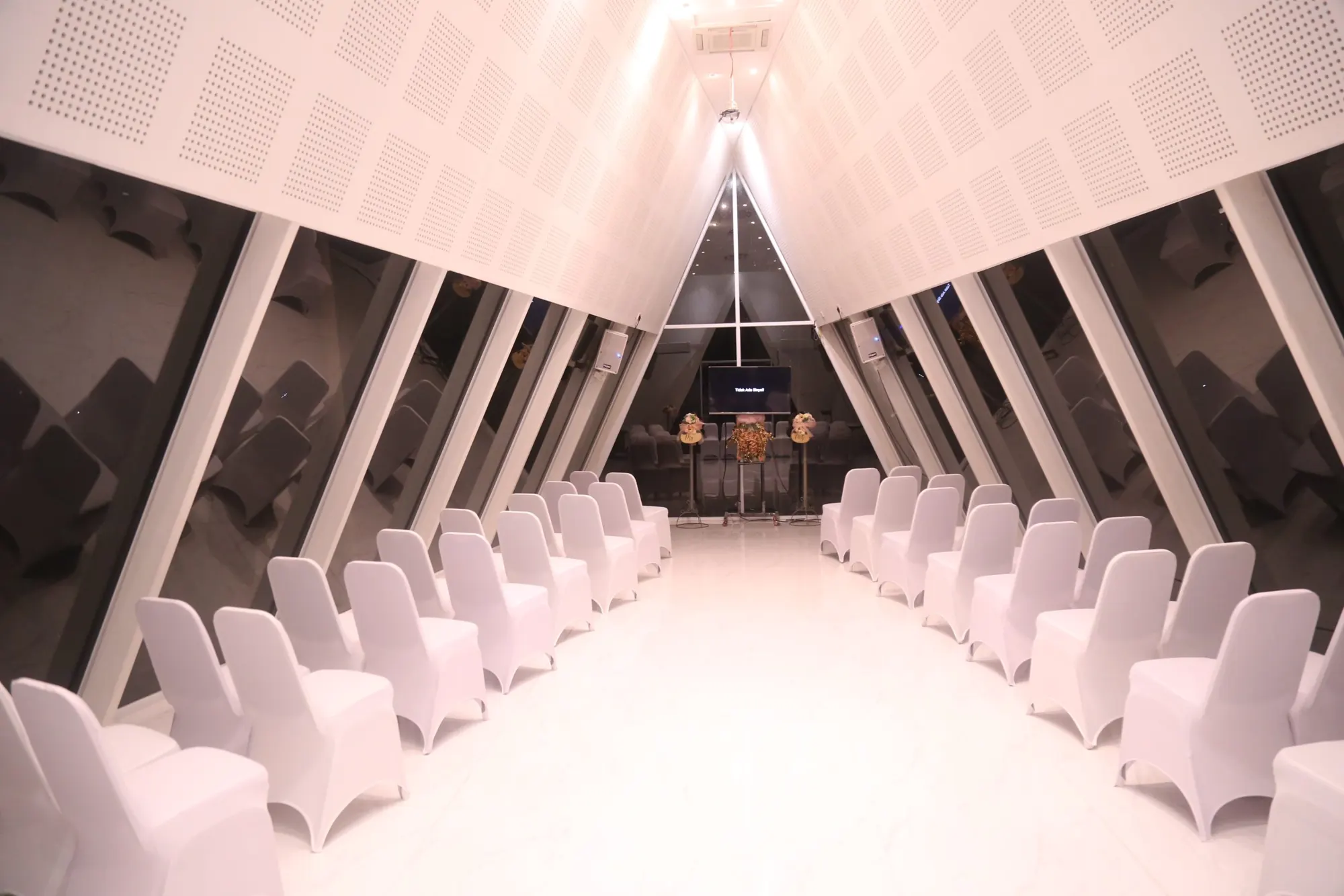 Interior Chapel LWJ dengan deretan kursi putih di bawah atap segitiga